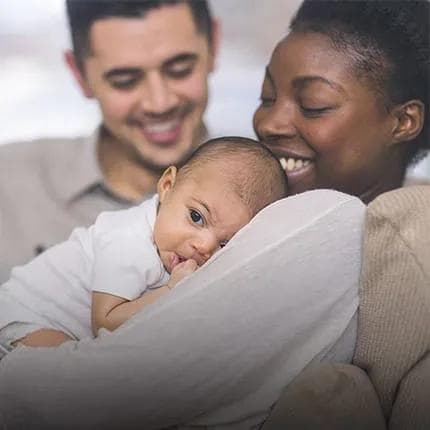 Parents cuddling with baby